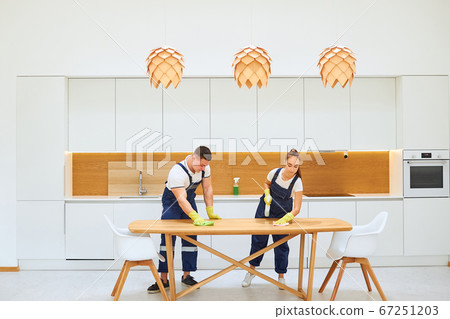 Housekeeping team cleaning kitchen table Housekeeping team cleaning kitchen table 67251203