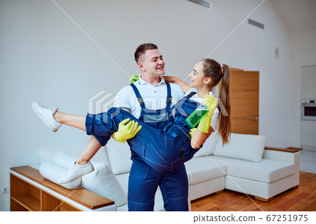 Young staff of cleaning service happy after cleaning new apartment Young staff of cleaning service happy after cleaning new apartment 67251975