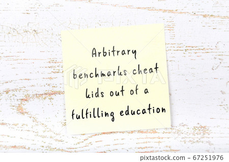 Yellow sticky note on wooden wall with wise quote Yellow sticky note on wooden wall with wise quote 67251976