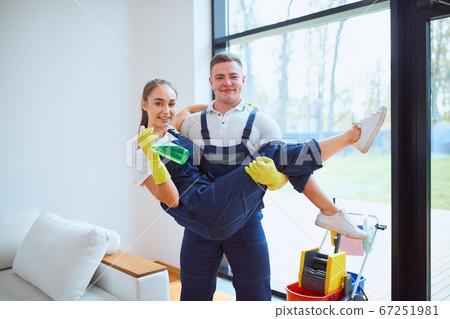happy young cleaning company workers together after work 67251981