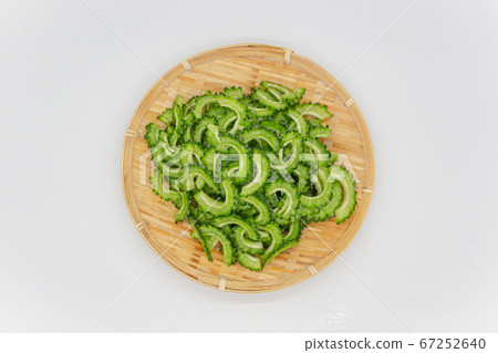 Cut bitter gourd on a colander, raw bitter gourd cut for snacks Cut bitter gourd on a colander, raw bitter gourd cut for snacks 67252640