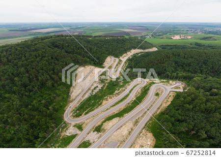 Aerial top vew of winding road in the mountains 67252814