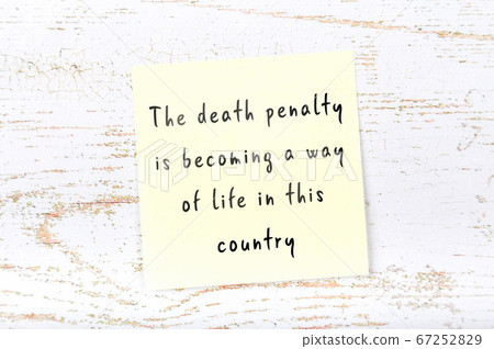 Yellow sticky note on wooden wall with wise quote Yellow sticky note on wooden wall with wise quote 67252829