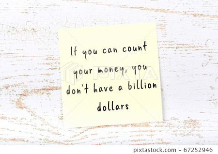 Wise quote on sticky note on wooden wall Wise quote on sticky note on wooden wall 67252946