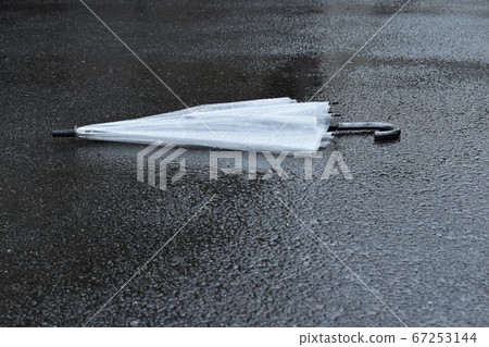Vinyl umbrella falling on the road Vinyl umbrella falling on the road 67253144