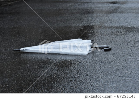 Vinyl umbrella falling on the road Vinyl umbrella falling on the road 67253145