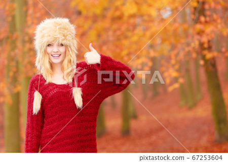 Pretty smiling woman in fur hat with thumb up. Pretty smiling woman in fur hat with thumb up. 67253604