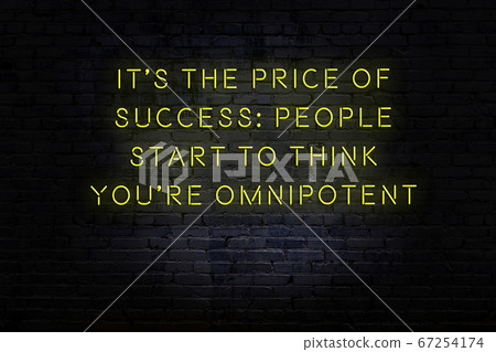Wise quote. Neon inscription against brick wall 67254174