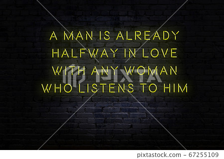Wise quote. Neon inscription against brick wall 67255109