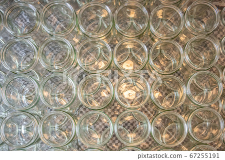 many glass jar empty glasses row for jam honey with lid caps abstract background bokeh 67255191
