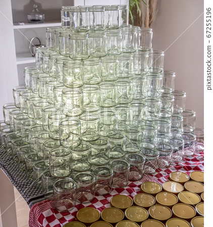 many glass jar empty glasses row for jam honey with lid caps abstract background bokeh 67255196