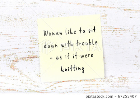 Yellow sticky note on wooden wall with wise quote Yellow sticky note on wooden wall with wise quote 67255407