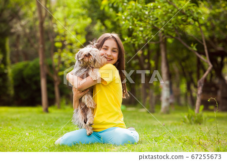 The happy girl and her four-legged friend 67255673