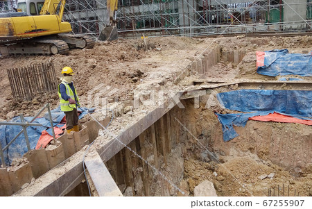 KUALA LUMPUR, MALAYSIA -JUNE 29, 2017: Construction workers spraying the anti termite chemical treatment to the soil at the construction site. KUALA LUMPUR, MALAYSIA -JUNE 29, 2017: Construction workers spraying the anti termite chemical treatment to the soil at the construction site. 67255907