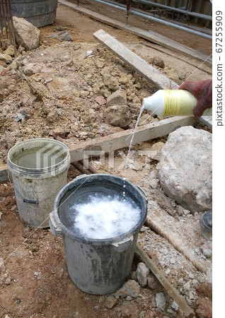 KUALA LUMPUR, MALAYSIA -JUNE 29, 2017: Construction workers spraying the anti termite chemical treatment to the soil at the construction site.  67255909