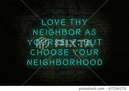 Wise quote. Neon inscription against brick wall 67256278