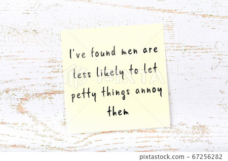 Wise quote on sticky note on wooden wall  67256282