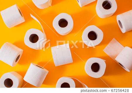 Top view of toilet paper rolls on the yellow 67256428