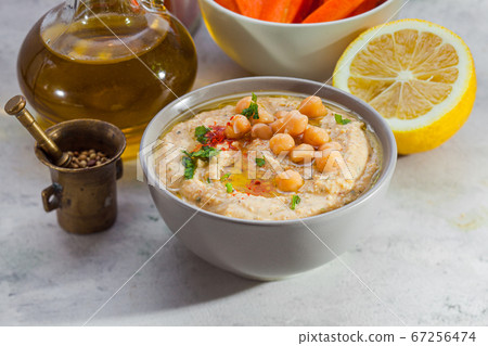 Ceramic bowl with hummus spread and its ingredients Ceramic bowl with hummus spread and its ingredients 67256474