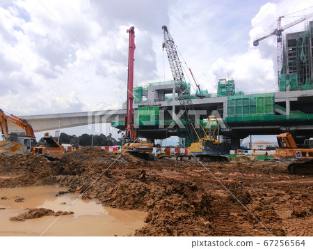KUALA LUMPUR, MALAYSIA -JULY 01, 2017: Bore pile driving work by bore pile rig at the construction site. The machine used to driven pile for building foundation work. KUALA LUMPUR, MALAYSIA -JULY 01, 2017: Bore pile driving work by bore pile rig at the construction site. The machine used to driven pile for building foundation work. 67256564