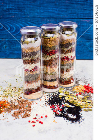 The glasses and scattered seeds are located on a white surface 67256618