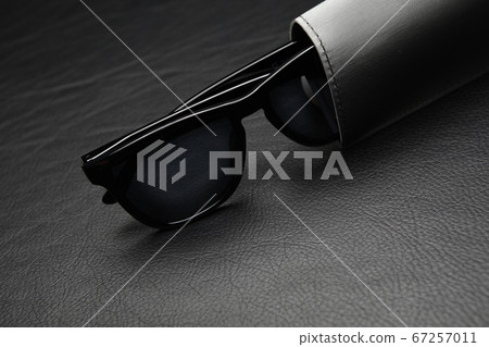 image of sunglasses dark leather background  67257011