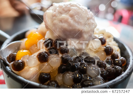 eating shaved ice with colorful dessert 67257247