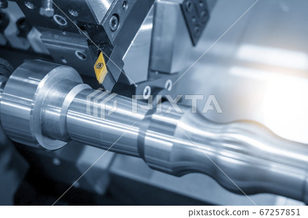 The  CNC lathe machine finish cutting the metal shaft. 67257851