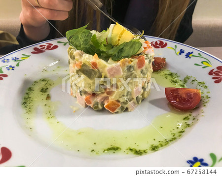 The girl eats Russian national salad "Olivier" The girl eats Russian national salad "Olivier" 67258144
