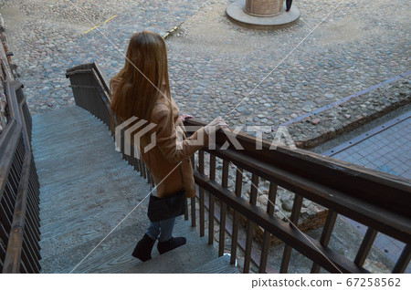 A beautiful young slim girl in a brown A beautiful young slim girl in a brown 67258562