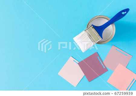 Can of white paint with a brush 67259939