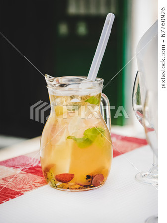 Jug of fresh cold white wine Sangria with fruit 67260926