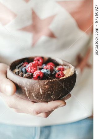 Woman holding healthy breakfast bowl with oats Woman holding healthy breakfast bowl with oats 67260927