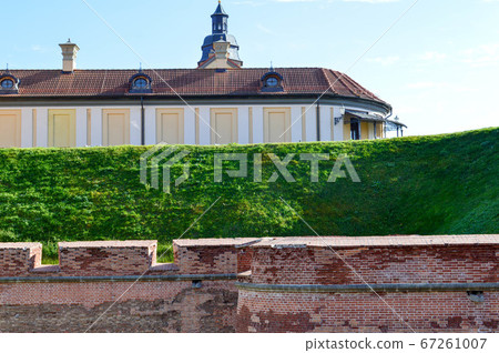 A large red brick earthen wall is strong A large red brick earthen wall is strong 67261007