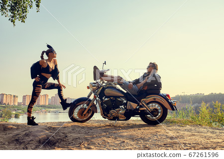 Sexy couple of bikers on the vintage custom motorcycle, girl in a rabbit mask 67261596