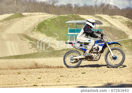 Motocross concept, a biker goes off-road making extreme skiing. In pursuit of adrinalin, sport concept. Dangerous sport. Motocross concept, a biker goes off-road making extreme skiing. In pursuit of adrinalin, sport concept. Dangerous sport. 67261643