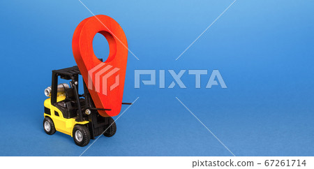 Yellow forklift carries a red location navigation pointer. Tracking. Transportation and delivery services. Moving cargo. Transfer and trade. Freight, production chains logistics and globalization. Yellow forklift carries a red location navigation pointer. Tracking. Transportation and delivery services. Moving cargo. Transfer and trade. Freight, production chains logistics and globalization. 67261714