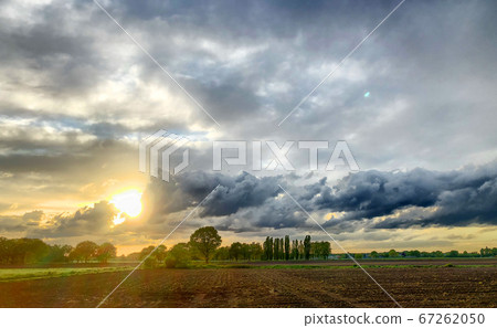 Countryside sunrise over the fields showing the dramatic colors in the sky.  67262050