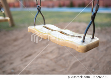 Childrens chain swing on the playground. Childrens chain swing on the playground. 67263580