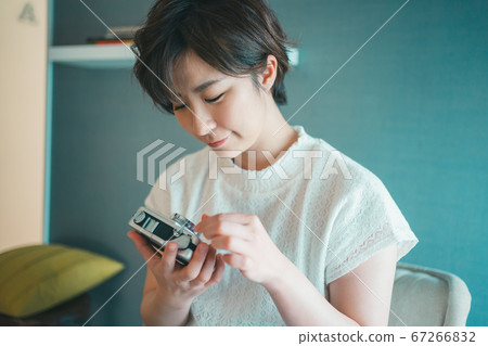 Camera girl checking camera Camera girl checking camera 67266832
