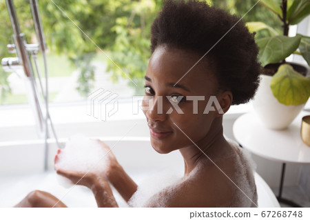 Portrait of woman in a bathtub Portrait of woman in a bathtub 67268748