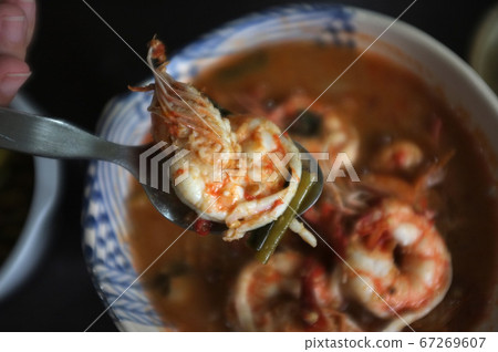 Close up Woman hand hold a spoon with shrimp from Close up Woman hand hold a spoon with shrimp from 67269607