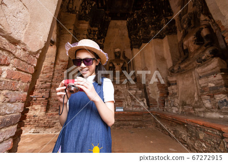Cute happy smiling tourist girl,relaxing enjoying travelling at Wat Chaiwatthanaram is a Buddhist temple in the city of Ayutthaya Historical Park,Thailand, summer vacation,travel concept. Cute happy smiling tourist girl,relaxing enjoying travelling at Wat Chaiwatthanaram is a Buddhist temple in the city of Ayutthaya Historical Park,Thailand, summer vacation,travel concept. 67272915