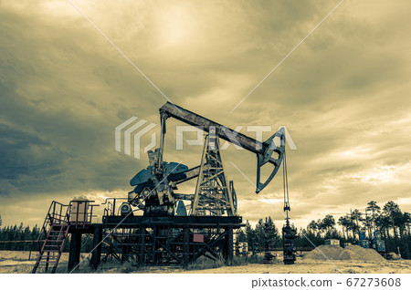 Petroleum concept. Oil pump rig. Oil and gas production. Oilfield site. Pump Jack are running. Drilling derricks for fossil fuels output and crude oil production. Global crisis. War on oil prices. Petroleum concept. Oil pump rig. Oil and gas production. Oilfield site. Pump Jack are running. Drilling derricks for fossil fuels output and crude oil production. Global crisis. War on oil prices. 67273608