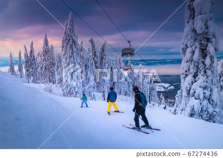 Winter ski resort with skiers and ski lift, Transylvania, Romania Winter ski resort with skiers and ski lift, Transylvania, Romania 67274436