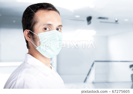 Asian man wearing a flu mask 67275605