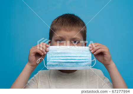 Portrait of child wearing an anti virus protection mask to prevent corona virus. 67277994