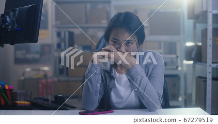 Bored young woman working in warehouse 67279519