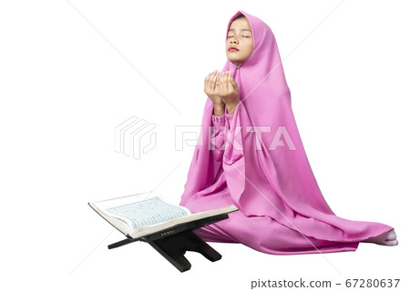 Asian Muslim woman in a veil sitting while raised 67280637