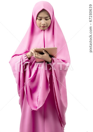 Asian Muslim woman in veil using tablet Asian Muslim woman in veil using tablet 67280639